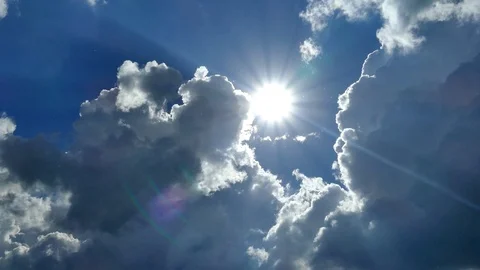 Beautiful white clouds fly across the sky against the blue sky and the sun. Video stock 108863174