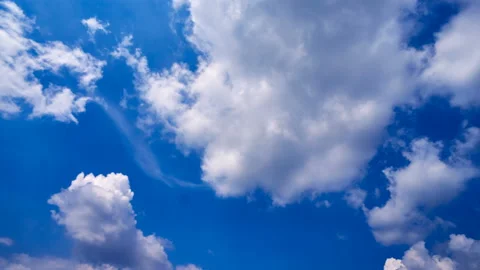 Beautiful white clouds move across the blue sky. Time Laps composition in motion Stock Footage 136770133
