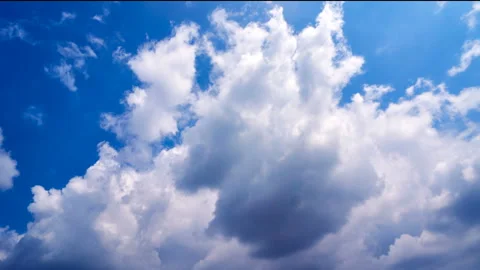 Beautiful white clouds move across the blue sky. Time Laps composition in motion Stock Footage 136771235