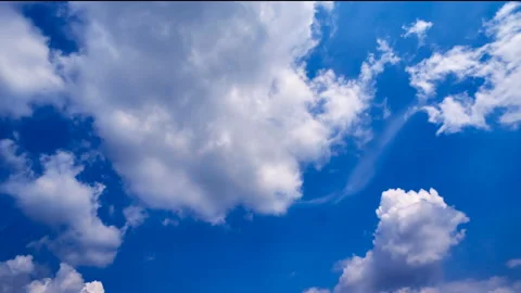 Beautiful white clouds move across the blue sky. Time Laps composition in motion Stock Footage 136771513