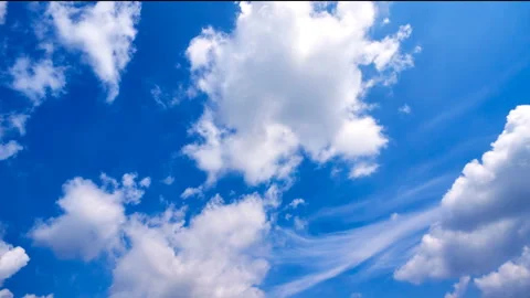 Beautiful white clouds move across the blue sky. Time Laps composition in motion Stock Footage 136773341