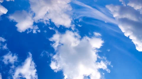 Beautiful white clouds move across the blue sky. Time Laps composition in motion Stock Footage 136775696