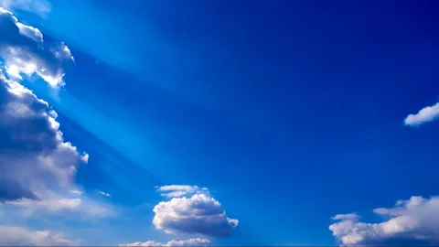 Beautiful white clouds move across the blue sky. Time Laps composition in motion Stock Footage 136777082