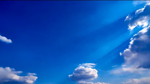 Beautiful white clouds move across the blue sky. Time Laps composition in motion Stock Footage 136777744