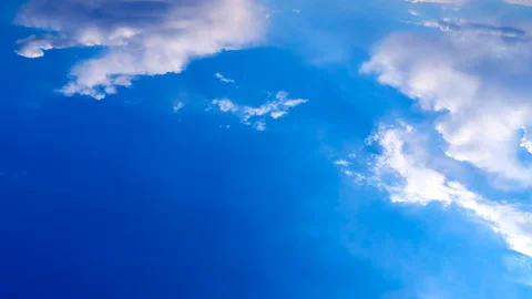 Beautiful white clouds move across the blue sky. Time Laps composition in motion Stock Footage 136778111