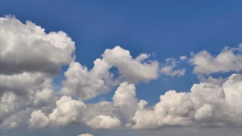 Beautiful white clouds passing below blue sky in time lapse clip Stock Footage 131432283