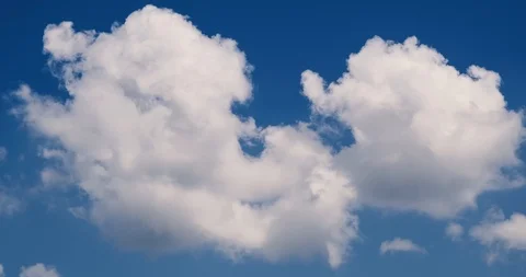 Beautiful white clouds soar across the screen in time lapse. Stock Footage 91383114