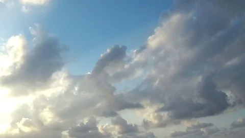 Beautiful white clouds in time lapse over a light blue background Stock Footage 78601160