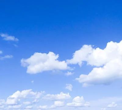 Beautiful white fluffy clouds in the blue sky. Stock Photos