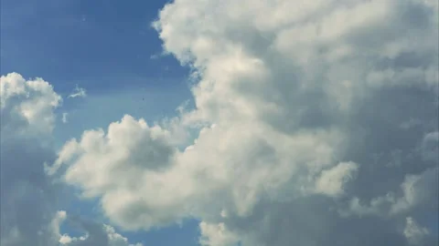 Beautiful white fluffy clouds slowly float against the blue sky. Timelapse video Stock Footage 307758158