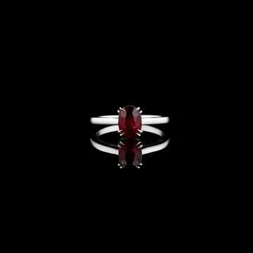 Beautiful white gold ring with a ruby on a black background Stock Photos