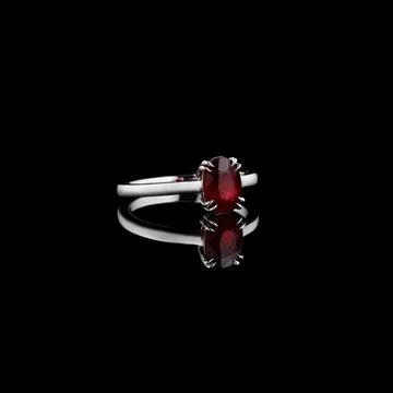 Beautiful white gold ring with a ruby on a black background 스톡 사진