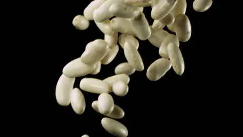 Beautiful white kidney beans falling in slow motion Stock Footage 151108885