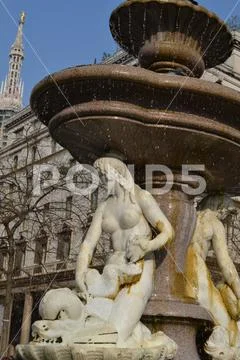 Beautiful white marble ancient three mermaid fountain in Milan. Stock Photos
