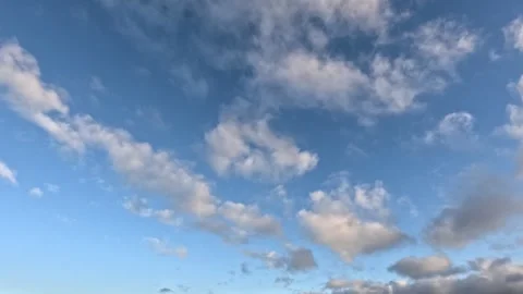 Beautiful white with pink tint clouds moving fast across the sky at dawn Stock Footage 306774791