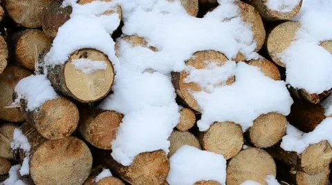 Beautiful white snow falling gently on background of wooden logs Stock Footage 50991049