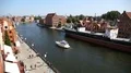 Beautiful white yacht sailing on Motlawa river in Gdansk, water transportation HD Footage