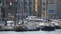 Beautiful white yachts with waving flags parked in Gdansk port, water transport HD Footage