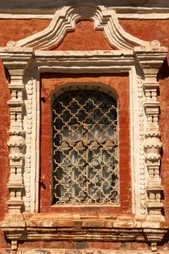 A beautiful window framed with stucco in an old building. Ancient architecture Stock Photos