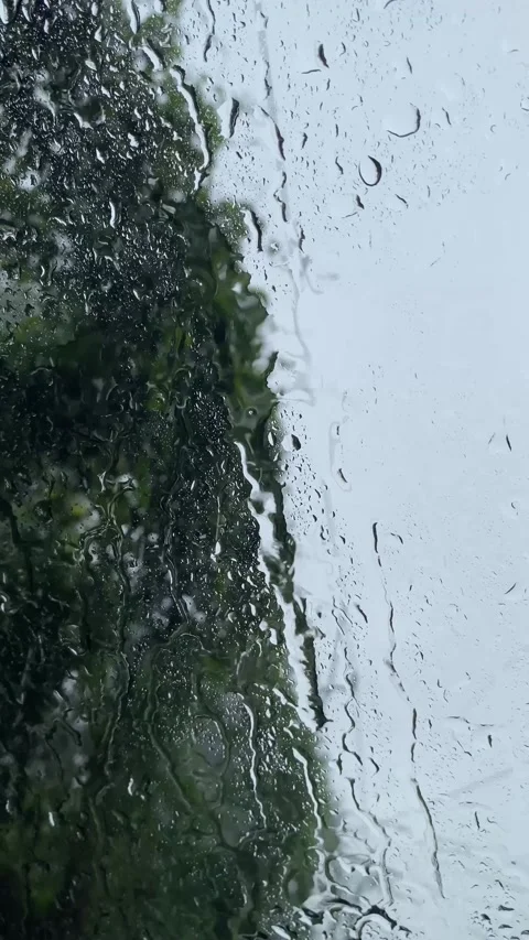 Beautiful window with rain falling on it Видео 299708917