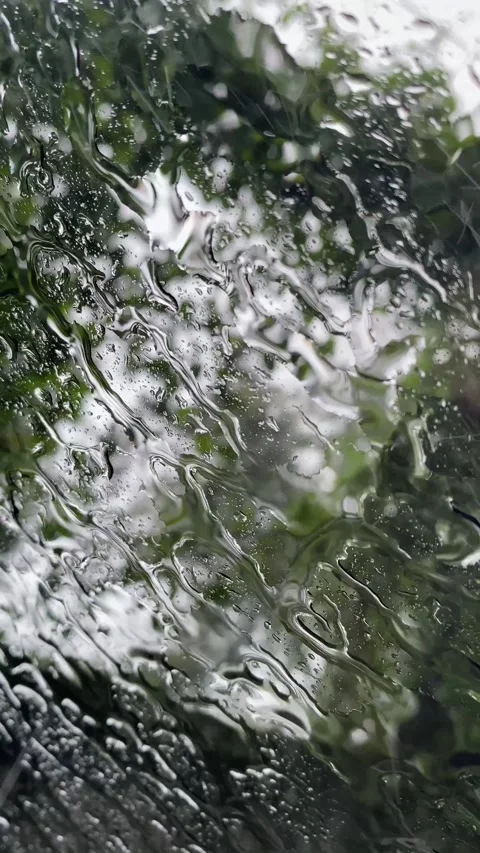 Beautiful window with rain falling on it Stockbeeldmateriaal 299710191