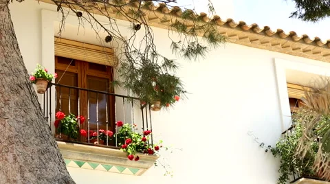 Beautiful window with red flowers. Spain, Altea Stock Footage 64854615