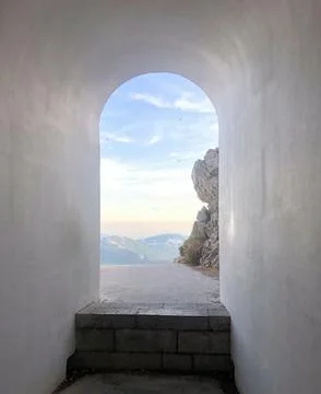 A beautiful window through which you can see the mountains and the beautiful sky Stock Photos