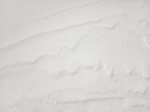 Beautiful winter background with sculptural patterns created by the wind on the 스톡 사진