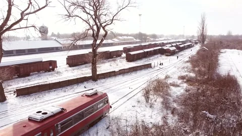 Beautiful winter day and train leaving the garage. Snow covering all. Stock Footage 149825070