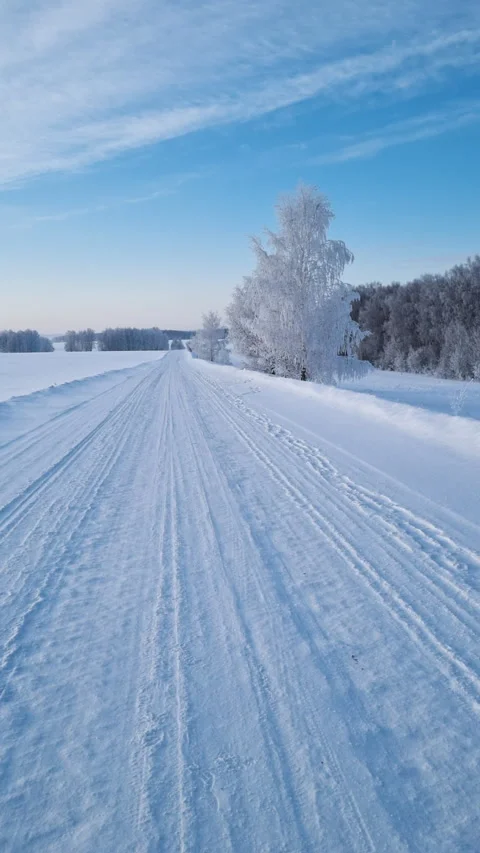 Beautiful winter landscape with a country road covered in snow. Stock Footage 327129853