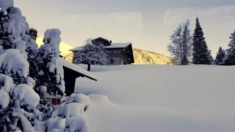 Beautiful Winter Landscape over Mountain Peak and Chalet and Tree in the Swiss Stock Footage 337855500