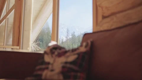 Beautiful winter mountain landscape seen through a window from a rustic and cozy Vidéo 334308688