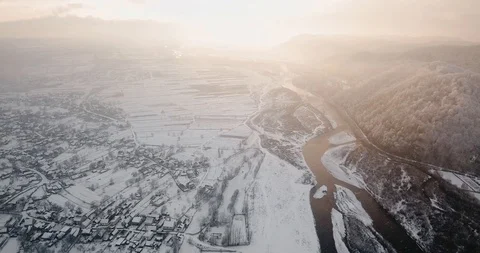 Beautiful winter river flying drone snowflakes whirls snowfall sunset 動画素材 122601419