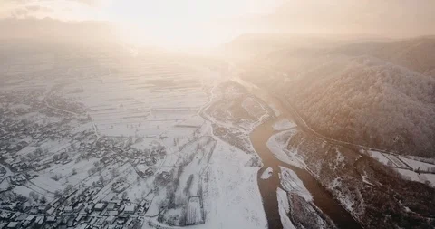 Beautiful winter river flying drone snowflakes whirls snowfall sunset Stock Footage 122601516