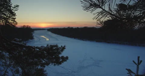 Beautiful winter snowy landscape while sunset. Beautiful view of frozen river Stock Footage 147383913