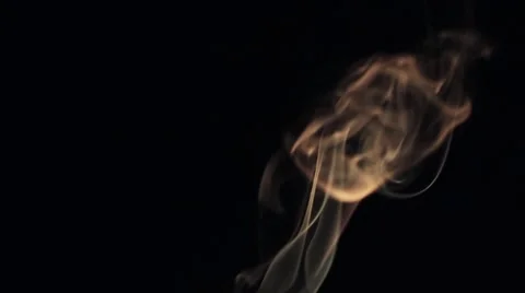 Beautiful wisp of smoke on a black background. Warm tone Stock Footage