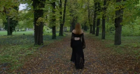 Beautiful Witch smiling in an evil way to the camera and turning around in Stock Footage 290491602