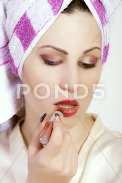 Beautiful woman applying lipstick Stock Photos
