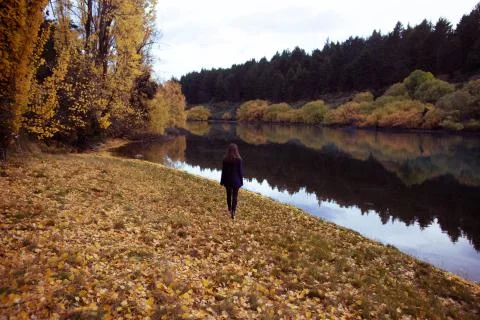Beautiful woman on Autumn day Clutha River New Zealand. High Resolution Photo. Stock Photos