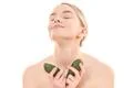 The beautiful woman with an avocado on the white background Photo