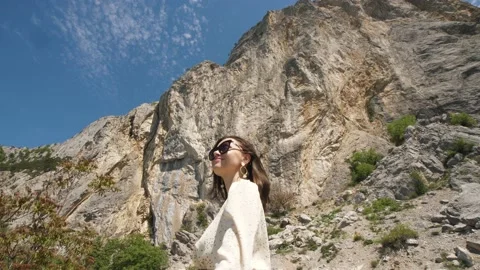 Beautiful woman on the background of mountains, sky Stock Footage 158921453
