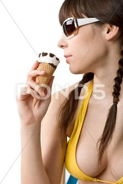 Beautiful woman in bikini with ice cream cone in summer Stock Photos