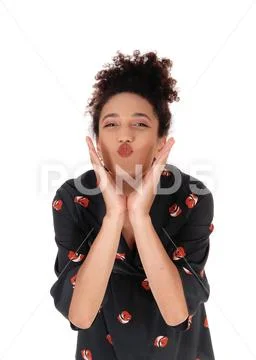 Beautiful woman blowing a kiss with hands on face Stock Photos