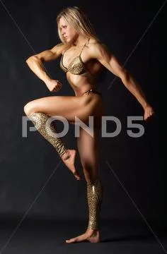 A beautiful woman bodybuilder in bikini marching Stock Photos