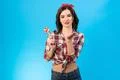 The beautiful woman with a candy gesturing on the blue background Photo