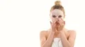 The beautiful woman with a clean mask touching the face on the white background 4k or 4k+ Resolution