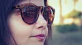 beautiful woman with the coliseum reflected in his glasses smiling HD Footage