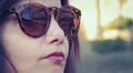 beautiful woman with the coliseum reflected in his glasses smiling at the camera HD Footage