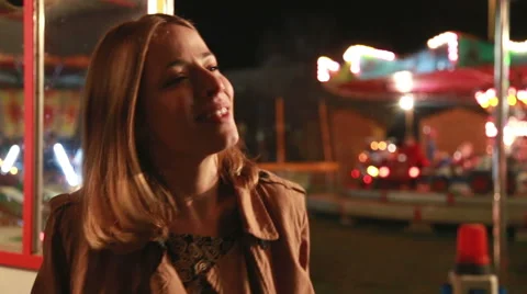 Beautiful woman dancing and smiling to the camera in amusement park Stock Footage 59556255