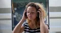 Beautiful Woman Dancing with Headphones Listening Music. Slow Motion. HD Footage